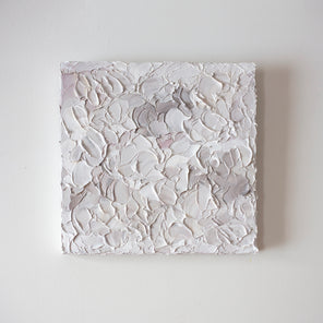 A light pink, white and warm grey impasto abstract painting. Hangs on a white gallery wall. 