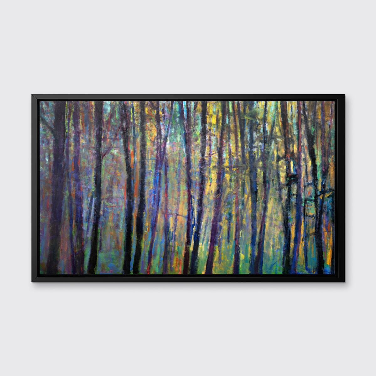 A multicolored abstract tree landscape print in a black floater frame hangs on a white wall.