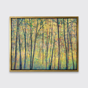 A yellow, brown and green abstract tree landscape print in a gold floater frame hangs on a white wall.