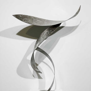 Stainless steel, nautical sculpture, from the front view, sitting on a pedestal in front of a white wall. 
