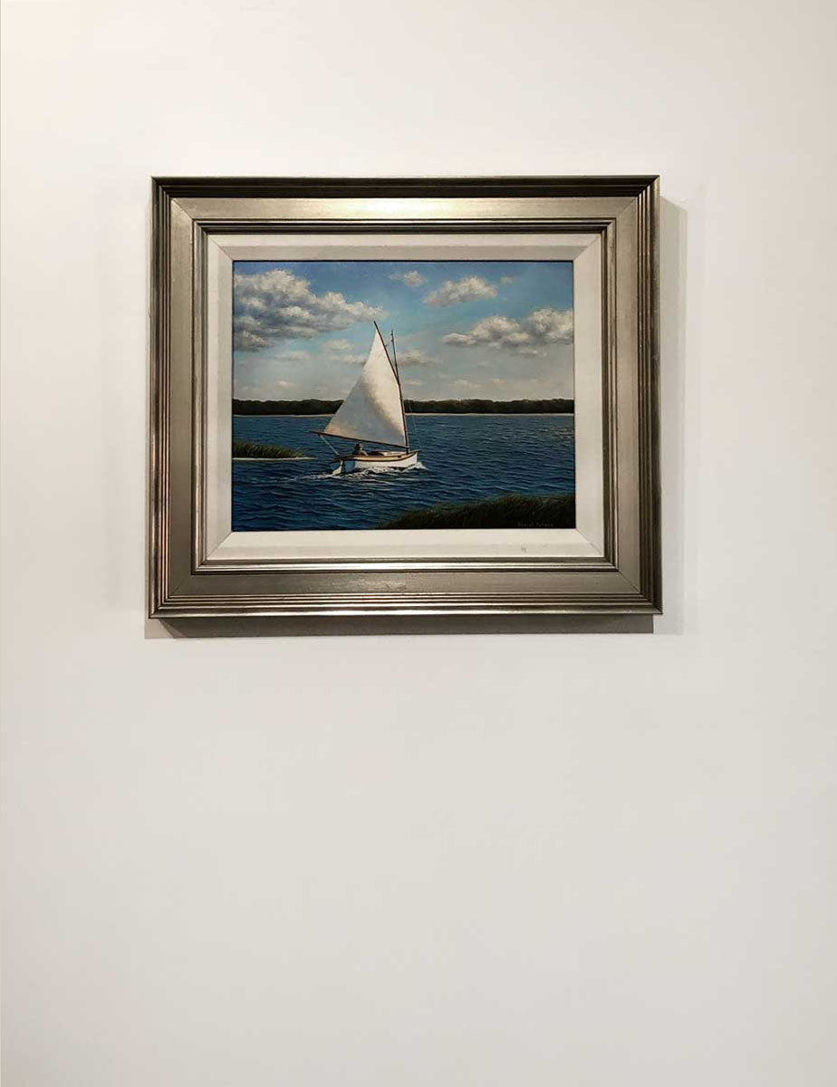 An oil paining of a sailboat going out to the bay, on a white wall.