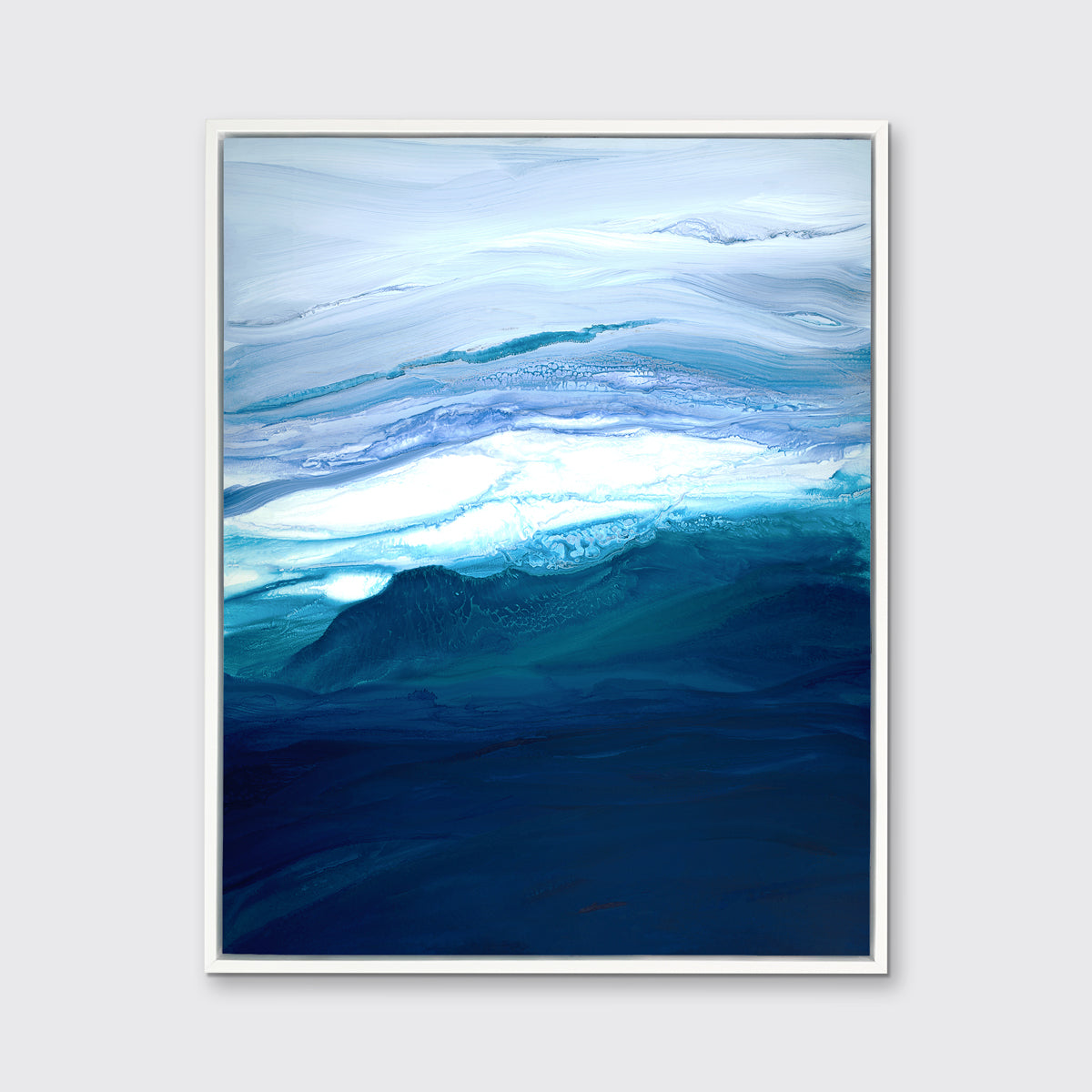 A blue, teal, lavender and white abstract print in a white floater frame hangs on a white wall.