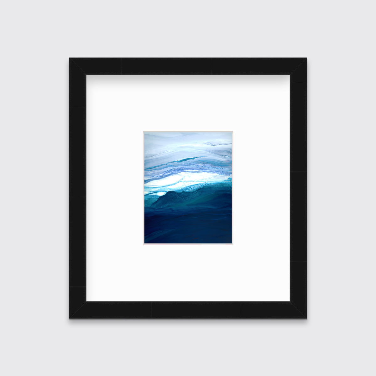 A blue, teal, lavender and white abstract print in a black frame with a mat hangs on a white wall.