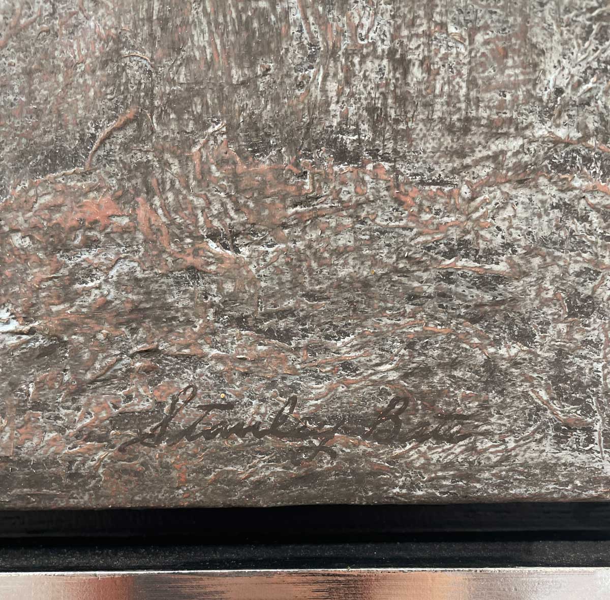 A close up of the artist's signature in the bottom right hand corner.