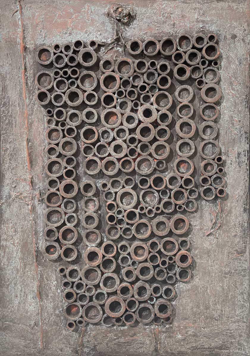 A grey and light rust orange abstract painting with embedded wood circles by Stanley Bate.
