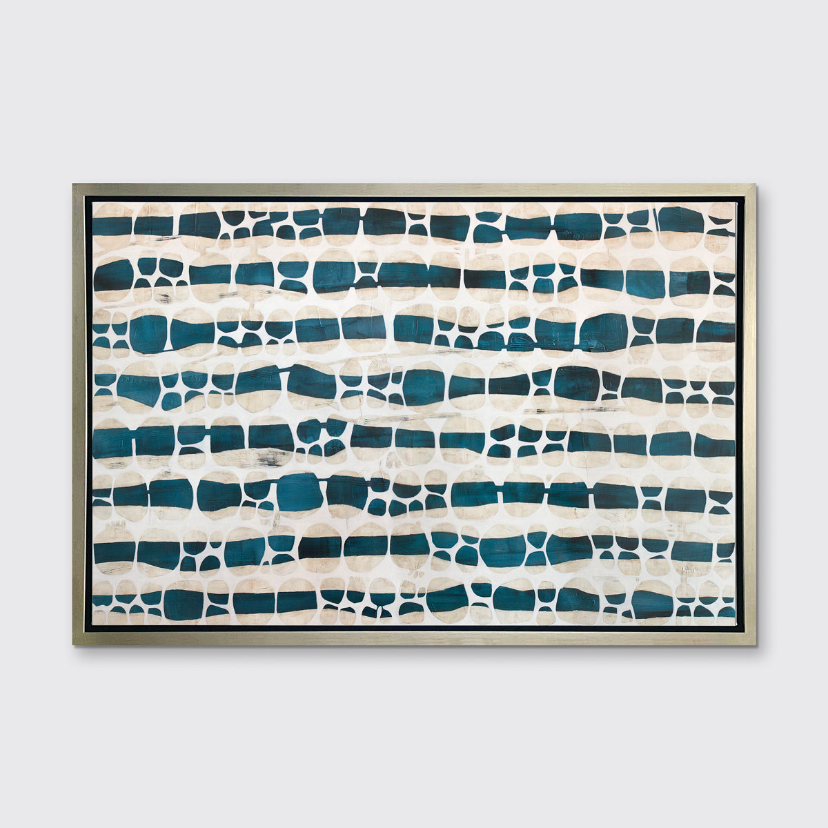 A white, dark teal and beige abstract print in a silver floater frame hangs on a white wall.