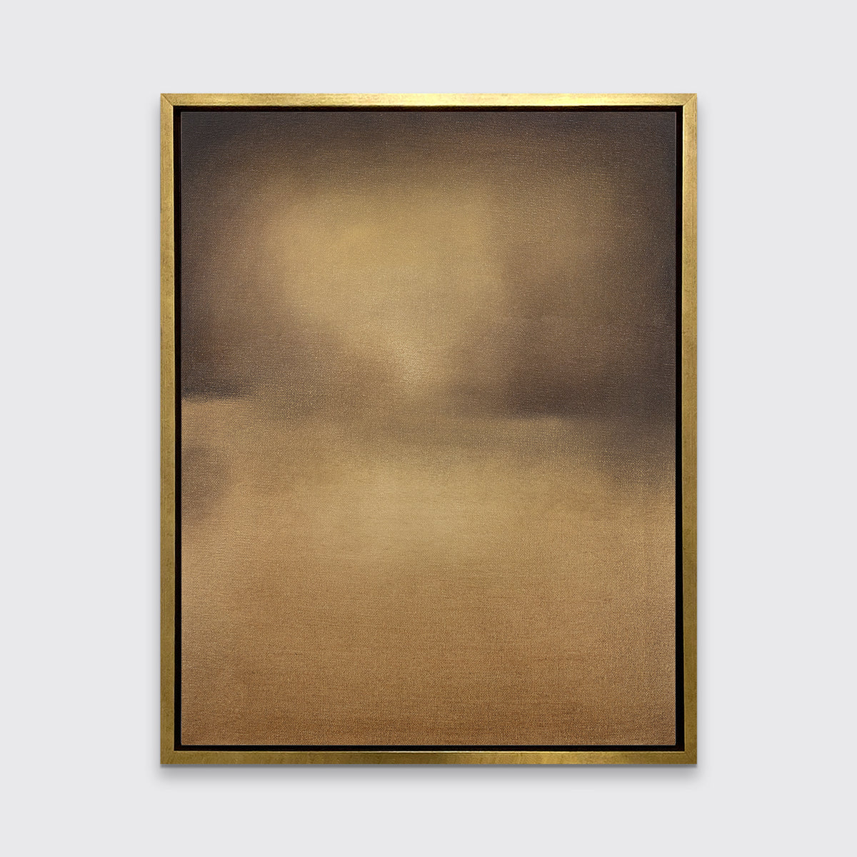 A brown and gold abstract print in a gold floater frame hangs on a white wall.