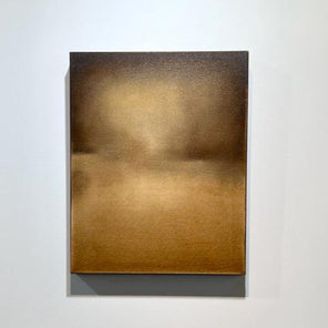 A brown, beige and goldenrod abstract painting by Tony Iadicicco hangs on a white wall.