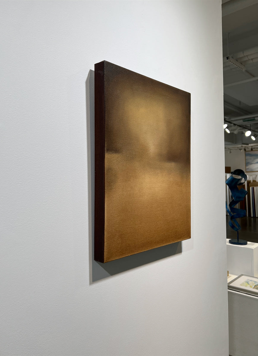 A left side-view of a brown, beige and goldenrod abstract painting by Tony Iadicicco hangs on a white wall.