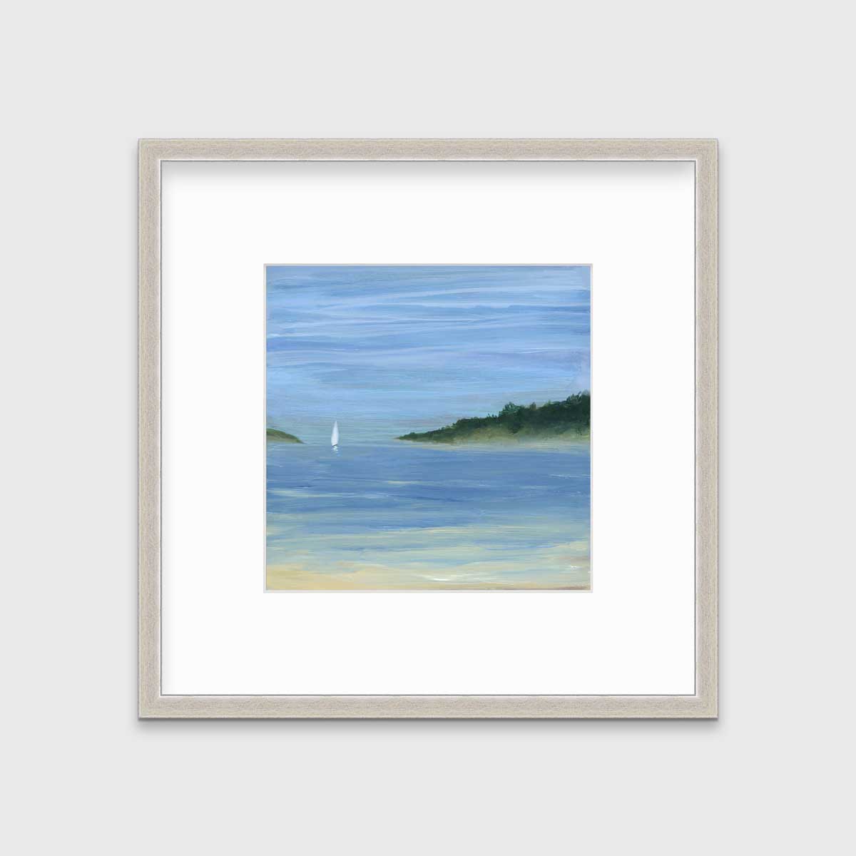 A blue, green and white abstract seascape print with a small sailboat in a silver frame with a mat hangs on a white wall.