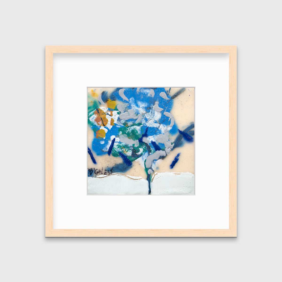 A blue, white, green and orange abstract print in a natural wood frame with a mat hangs on a white wall.