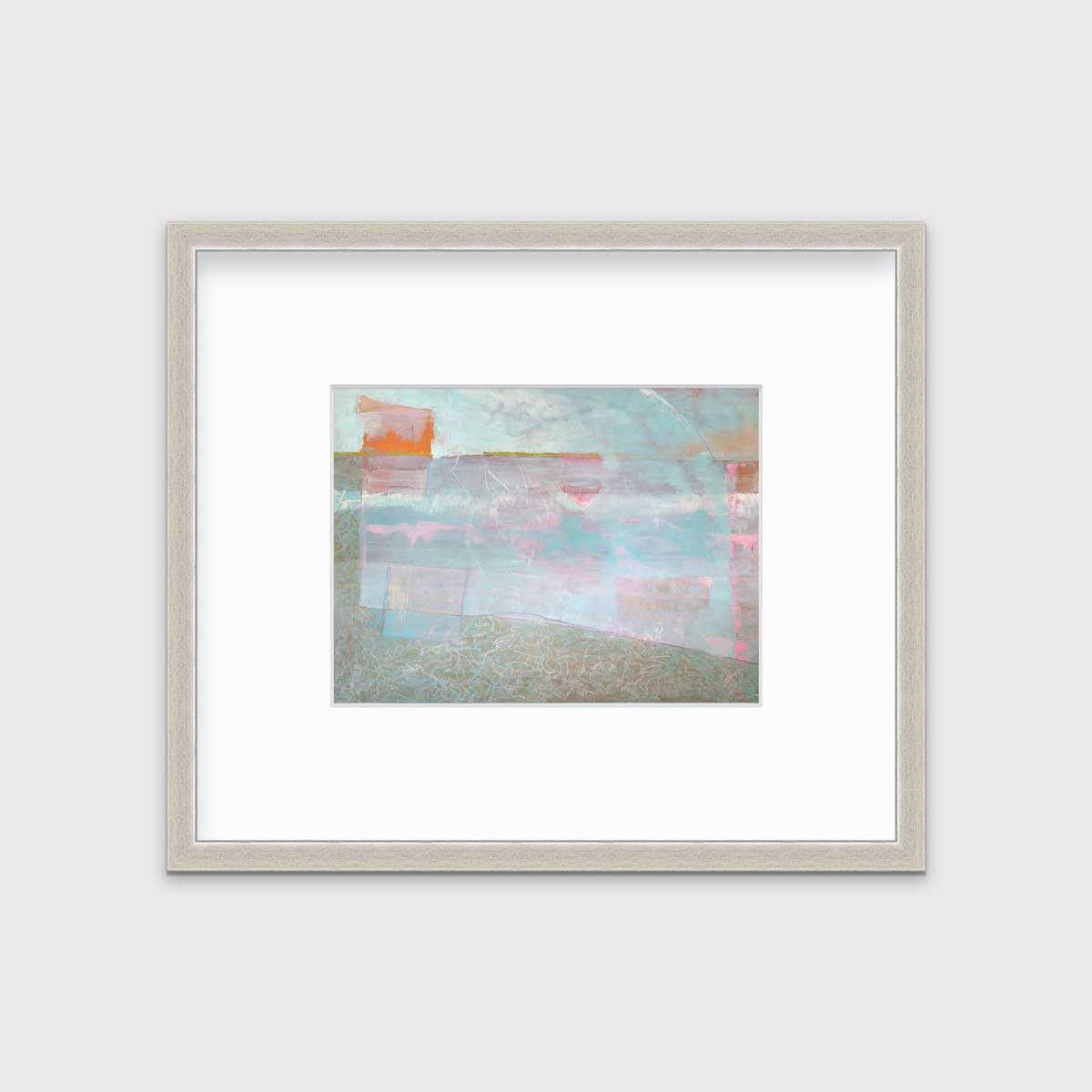 A light blue and pink abstract print in a silver frame with a mat hangs on a white wall.