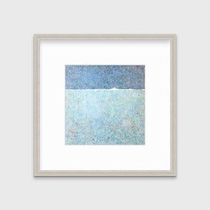 A blue abstract landscape print in a silver frame with a mat hangs on a white wall.