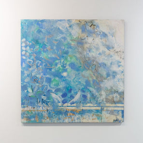 An encaustic painting with blue and turquoise marks is hung on a gallery wall. Wired and ready to hang.