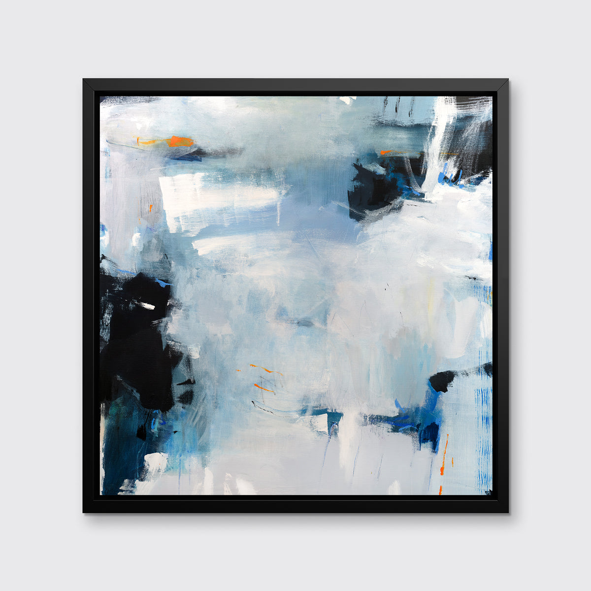 A blue and grey abstract print in a black floater frame hangs on a white wall.
