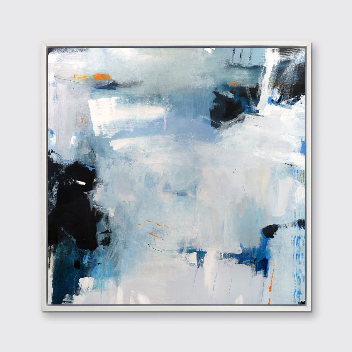 A blue and grey abstract print in a white floater frame hangs on a white wall.