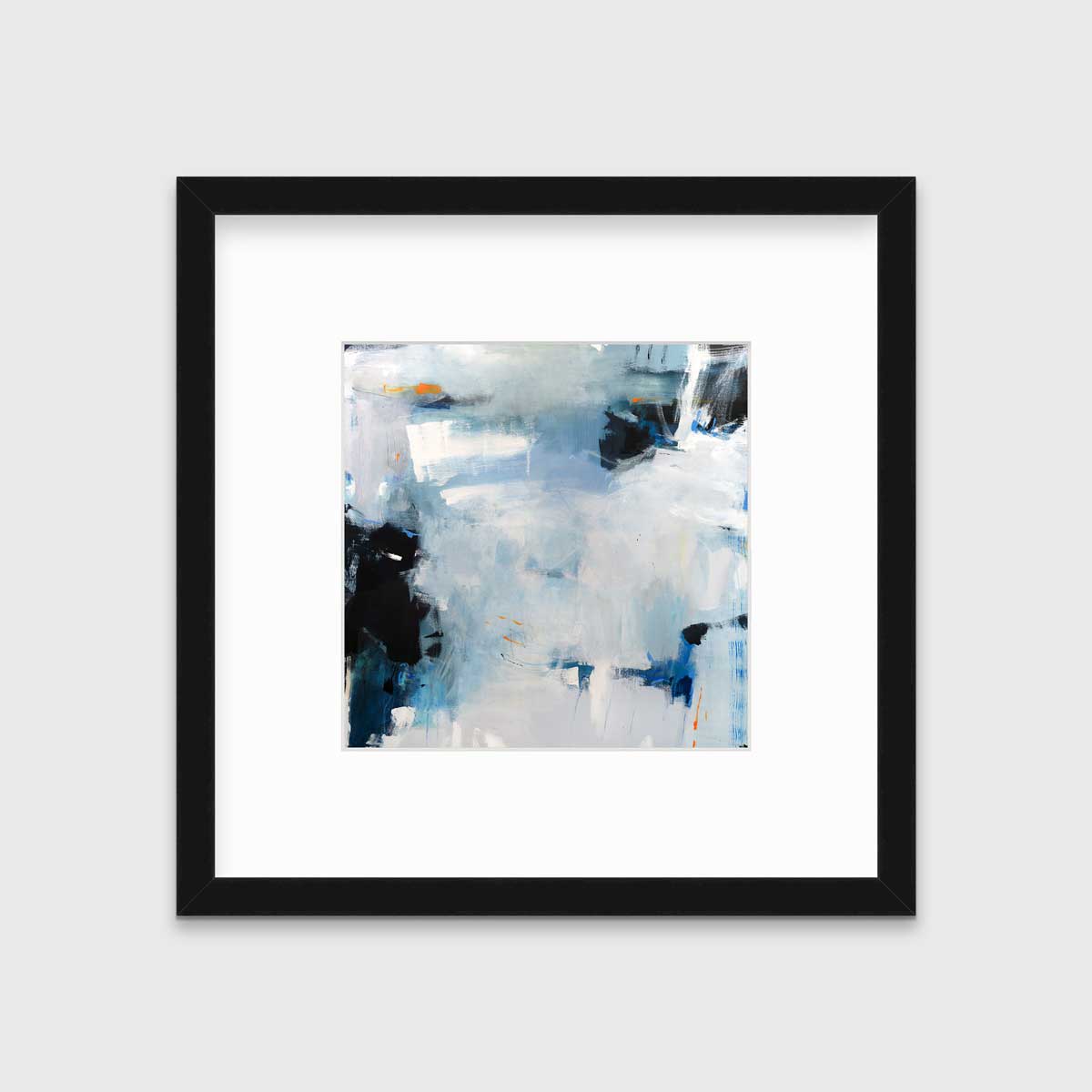 A blue and white abstract print in a black frame with a mat hangs on a white wall.