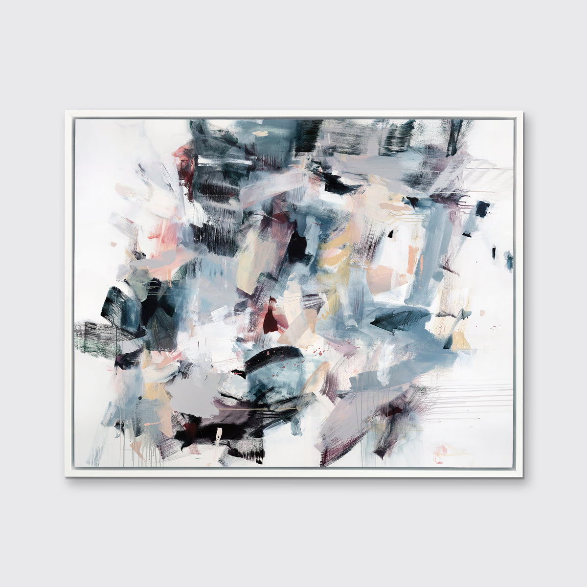 A multicolored abstract print in a white floater frame hangs on a white wall.