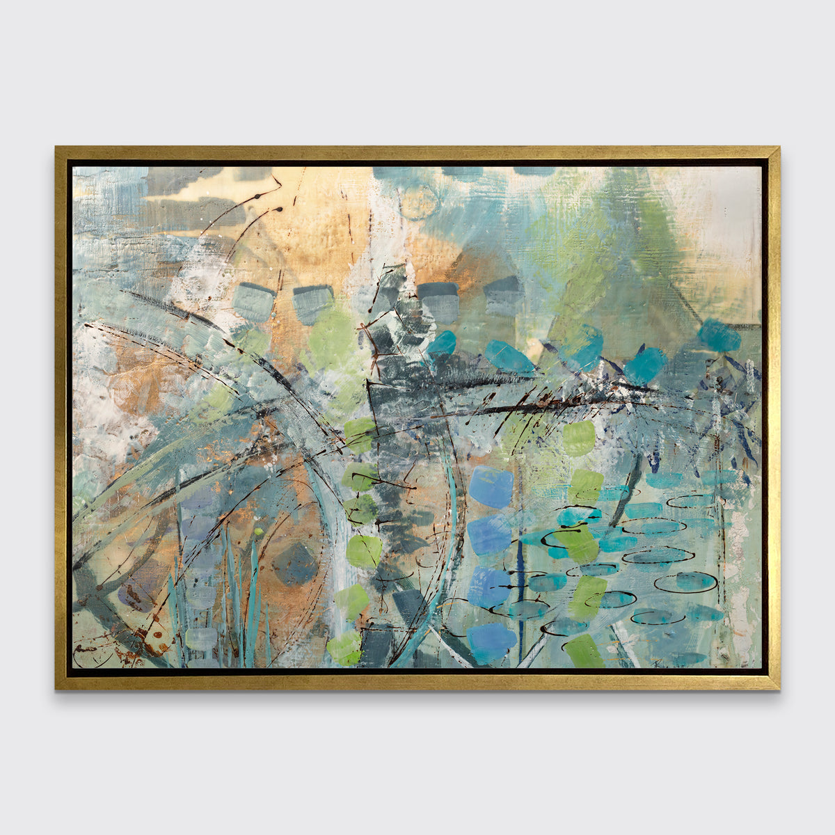 A blue, green, orange and black abstract print in a gold floater frame hangs on a white wall.
