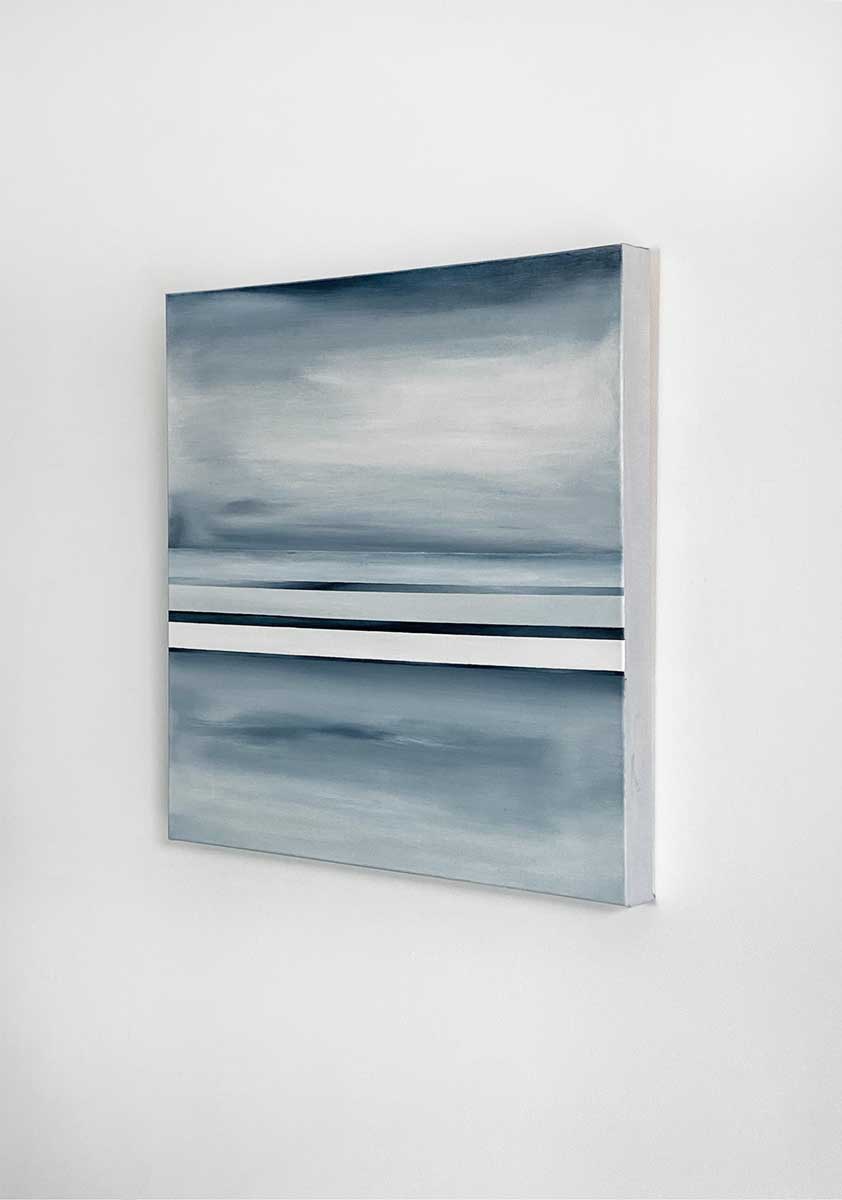 Side-angle view of an abstract painting featuring dark blue, grey and white horizontal lines hung on a white wall.