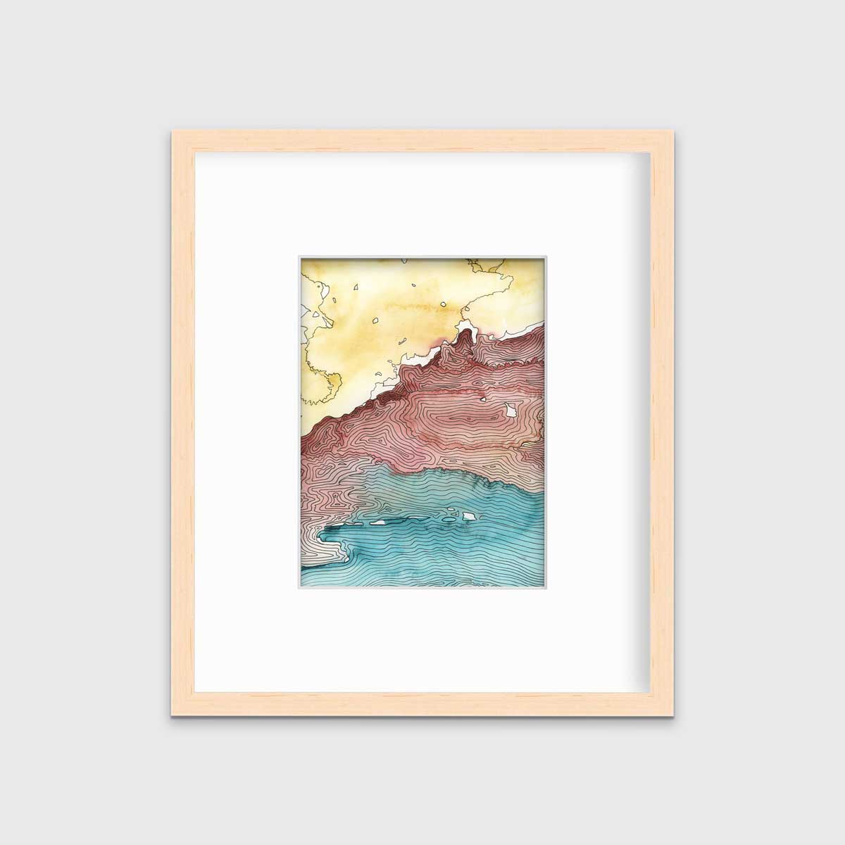 A yellow, dark red, teal and black abstract landscape print in a natural wood frame with a mat hangs on a white wall.