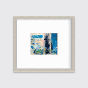 A blue, beige, gold and pink abstract figurative print in a silver frame with a mat hangs on a white wall.