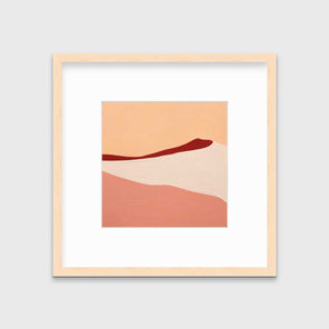 A red, peach and beige abstract print in a natural wood frame with a mat hangs on a white wall.