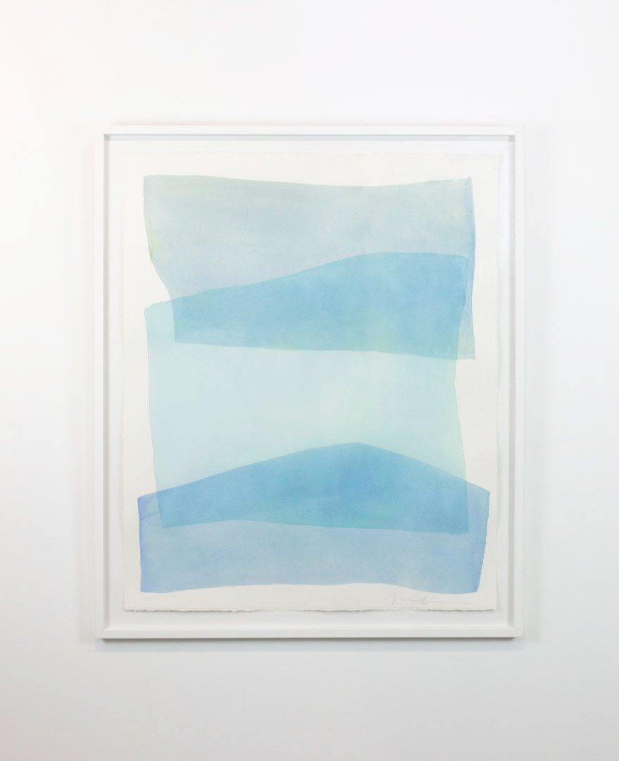 A watercolor painting of blue and turquoise stacked forms painted by Nealy Hauschildt is hung on a gallery wall.