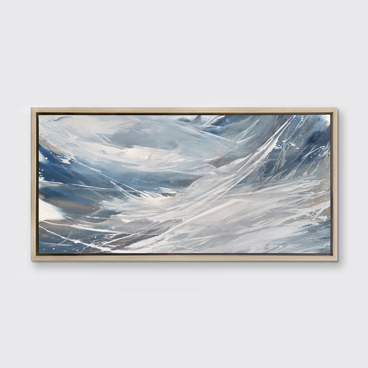 A grey, white and blue abstract print in a white oak wood floater frame hangs on a white wall.
