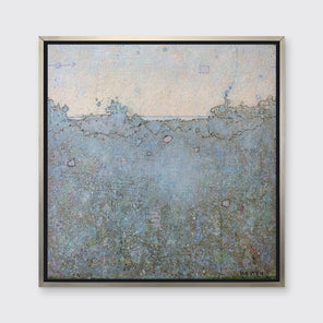 A dark blue abstract landscape print in a silver floater frame hangs on a white wall.