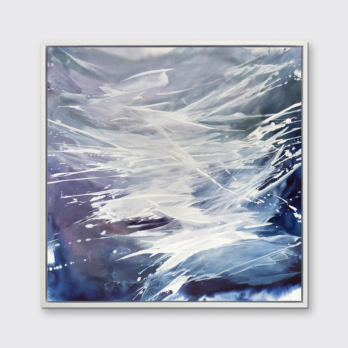 A purple, grey, white and blue abstract print in a white floater frame hangs on a white wall.