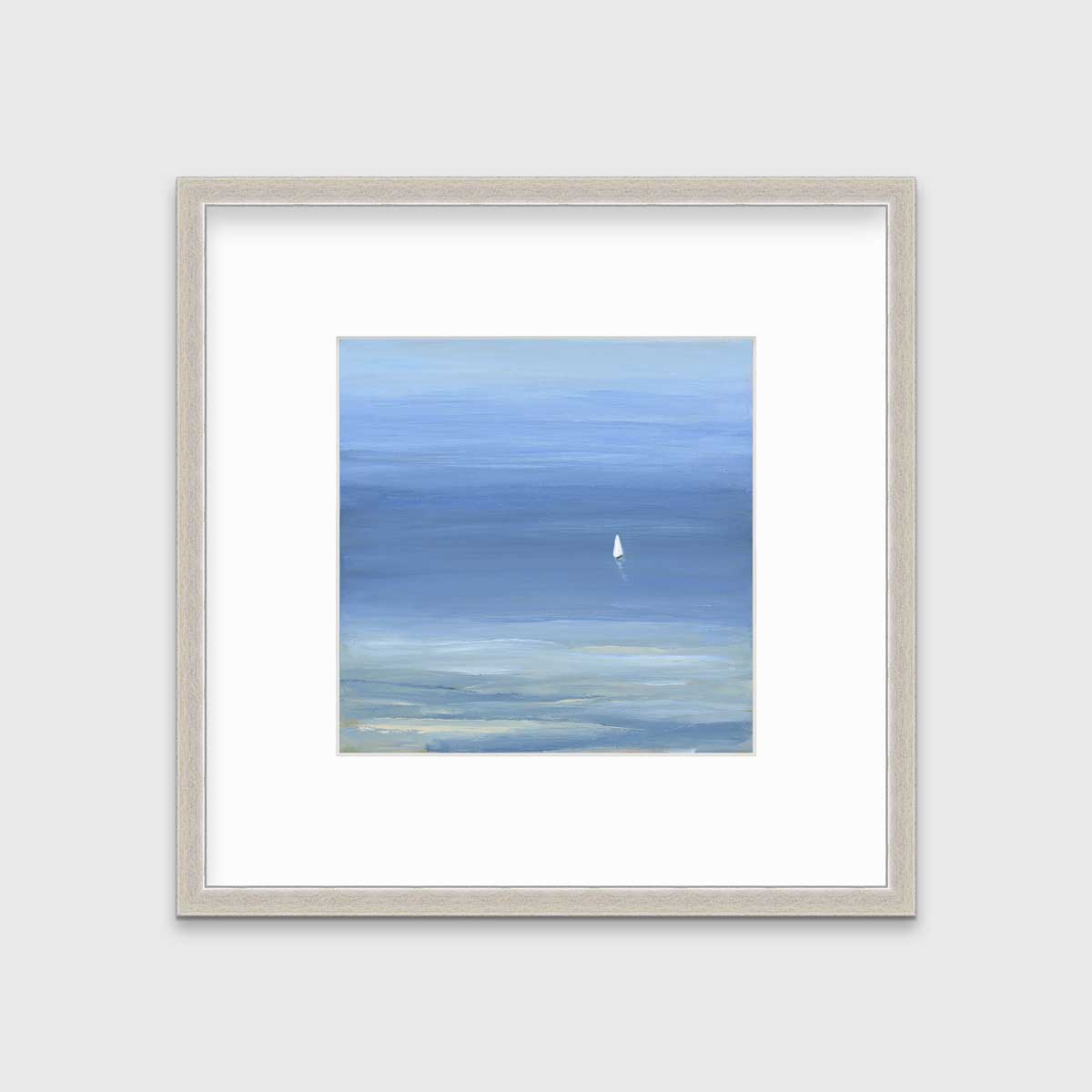 A blue, light green and white abstract seascape print with a small sailboat in a silver frame with a mat hangs on a white wall.