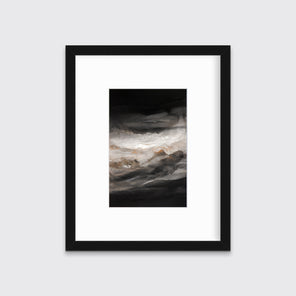 A black, white, beige and gold abstract print in a black frame with a mat hangs on a white wall.