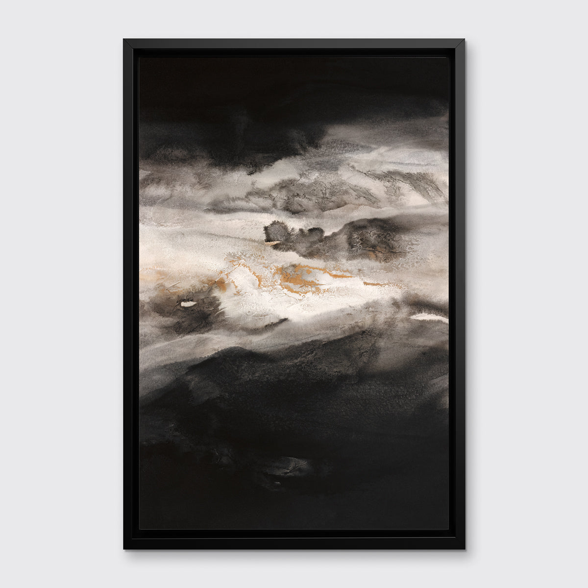A black, white, beige and gold abstract print in a black floater frame hangs on a white wall.