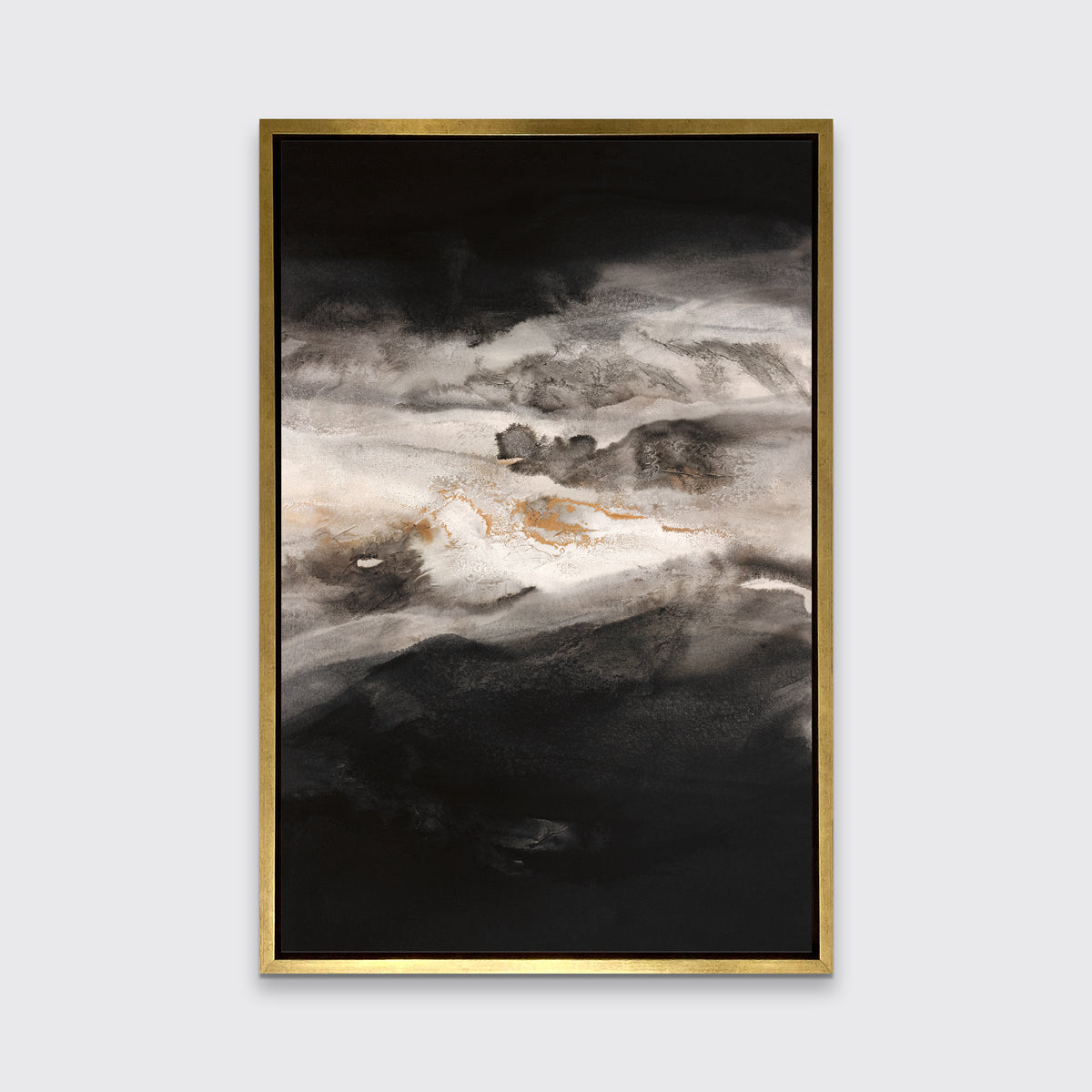 A black, white, beige and gold abstract print in a gold floater frame hangs on a white wall.