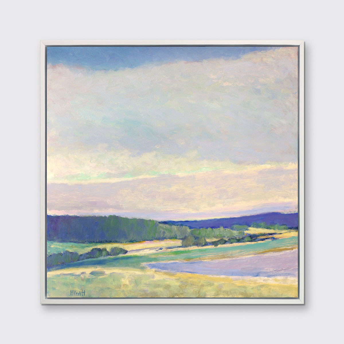 A blue, purple and green abstract landscape print in a white floater frame hangs on a white wall.