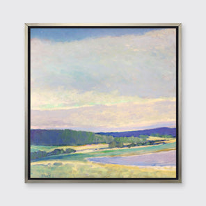 A multicolored abstract landscape print in a silver floater frame hangs on a white wall.