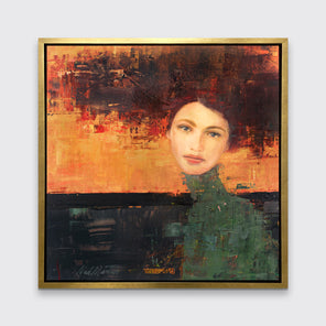 A orange, red, green and black abstract figural print in a gold floater frame hangs on a white wall.