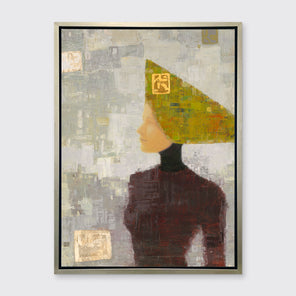 A grey, olive green and dark red abstract print of a woman with a headpiece in a silver floater frame hangs on a white wall.