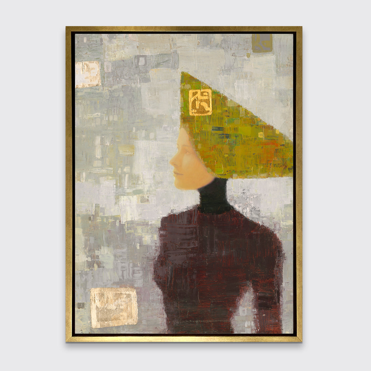 A grey, olive green and dark red abstract print of a woman with a headpiece in a gold floater frame hangs on a white wall.
