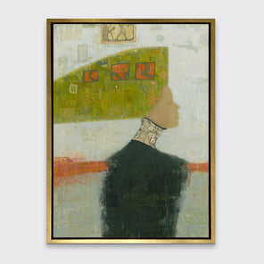 A grey, green and orange abstract print of a woman with a headpiece in a gold floater frame hangs on a white wall.