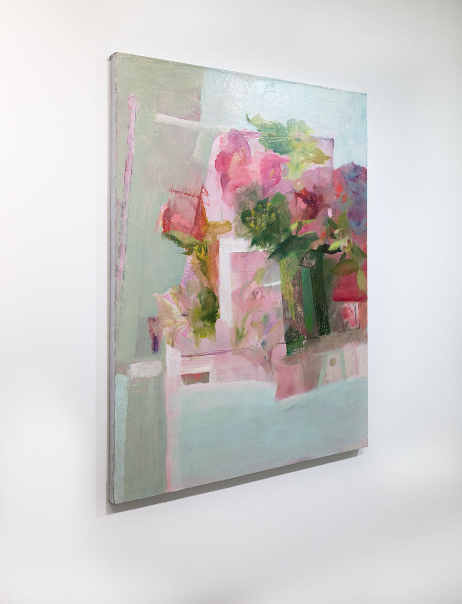 A painting depicts a green vase full of lush, pink roses and peonies. The painting is seen at an angle. This painting is wired and ready to hang.