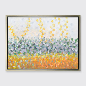 A yellow, purple, green and orange abstract print in a silver floater frame hangs on a white wall.