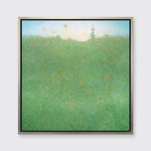 A green and light blue abstract landscape print in a silver floater frame hangs on a white wall.