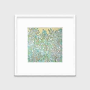 A green, yellow and white abstract print in a white frame with a mat hangs on a white wall.