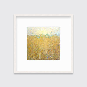 A yellow abstract landscape print in a whitewashed frame with a mat hangs on a white wall.