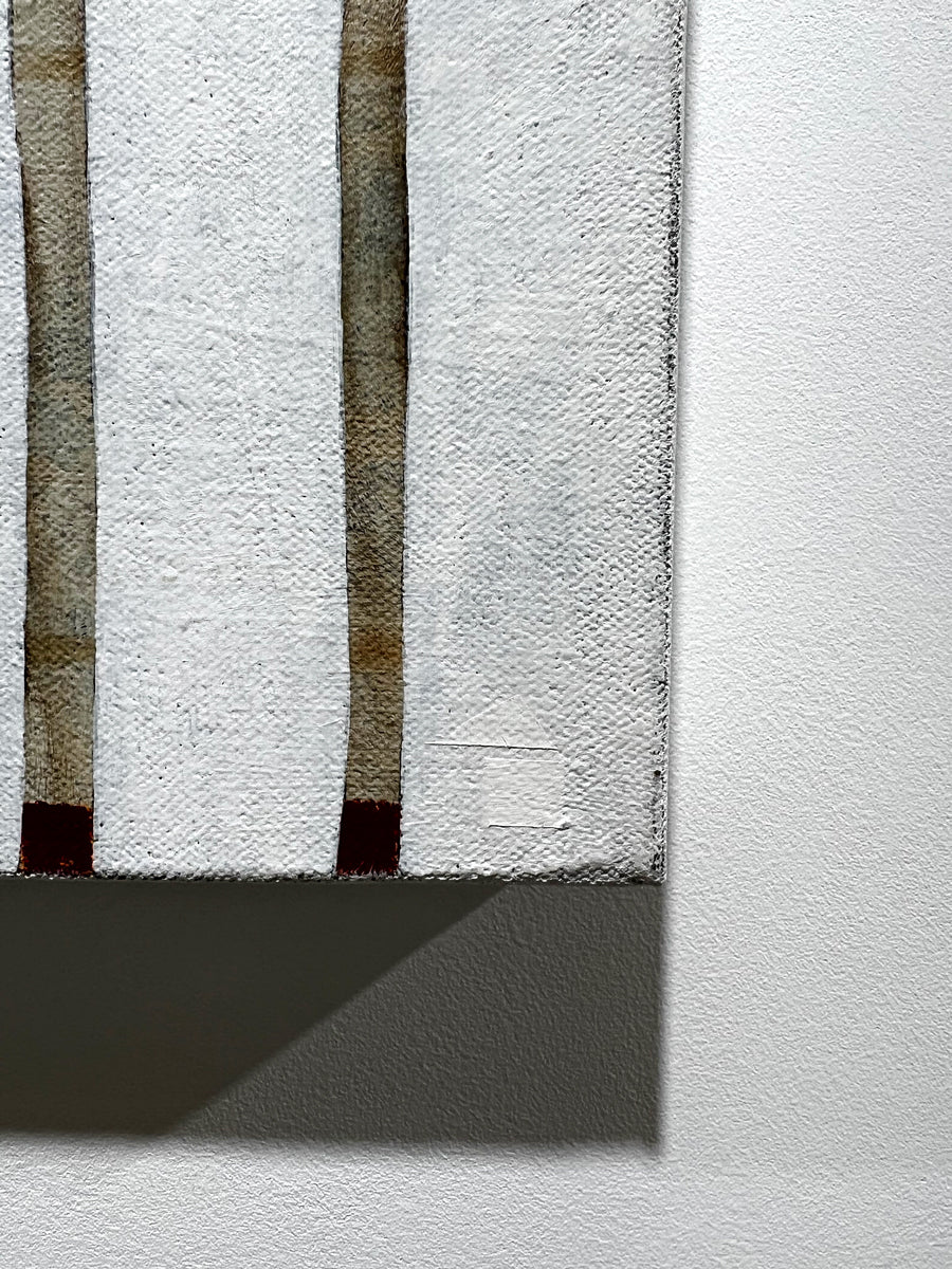 A detail image of artist Sofie Swann's signature of house in white on the minimalist painting. 