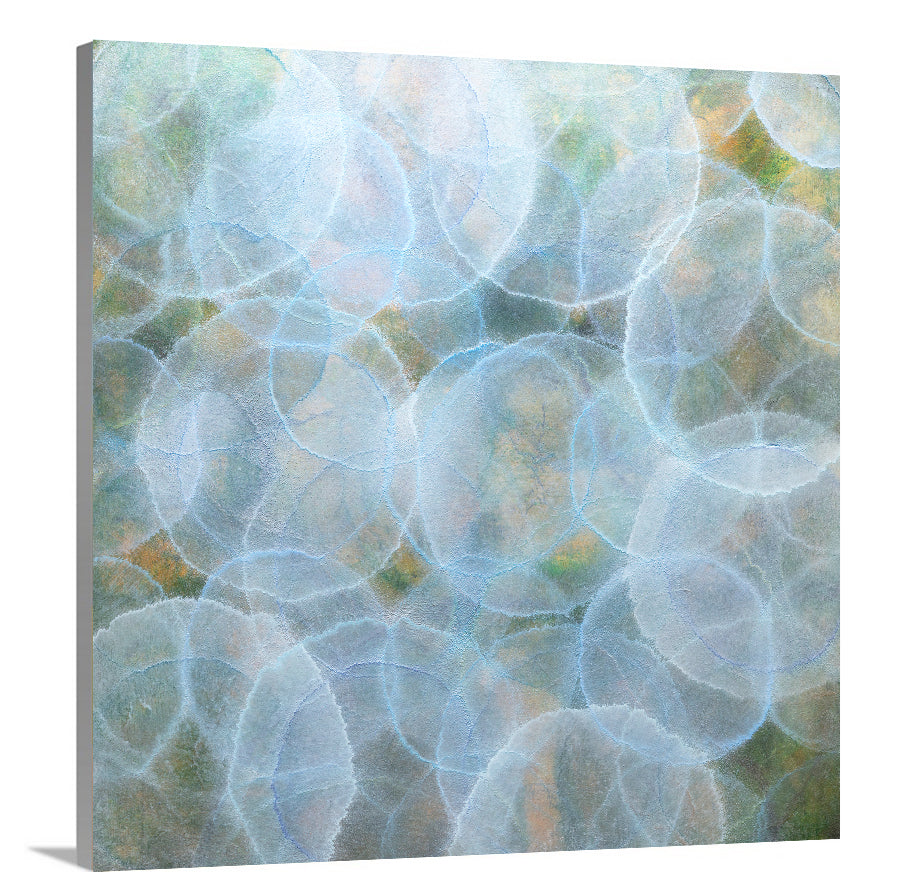 A side-angle view of a light blue, green and yellow abstract geometric print on canvas.