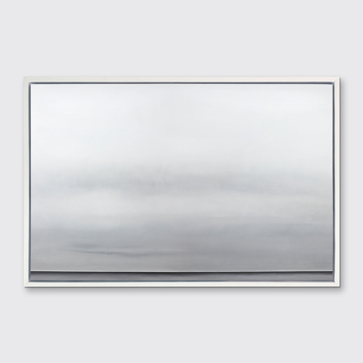 A tonal grey abstract landscape print in a white floater frame hangs on a white wall.