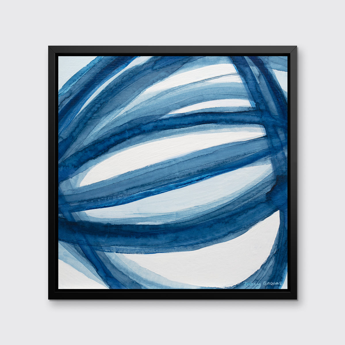 A blue and white abstract print in a black floater frame hangs on a white wall.